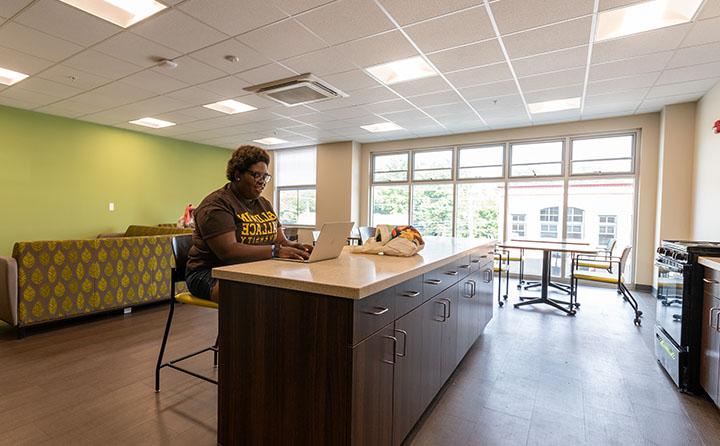 Photo of Student in Front Street Residence Hall Lounge